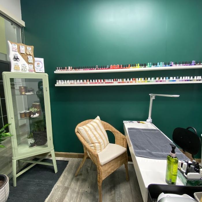 Inside Neneh's studio: green walls, polish wall and nail station